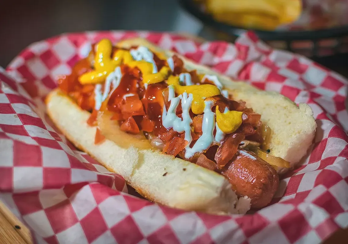 Hot dog with ketchup and mustard and toppings